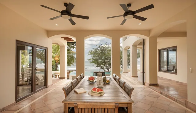 Covered dining terrace with ocean views at an Adventure Collection home