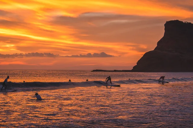 Surfers at Playa Los Perros at sunset