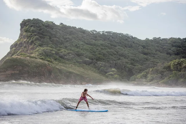 A guest learning to surf at Playa Los Perros